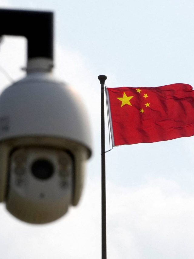Surveillance camera is seen near a Chinese flag in Shanghai
